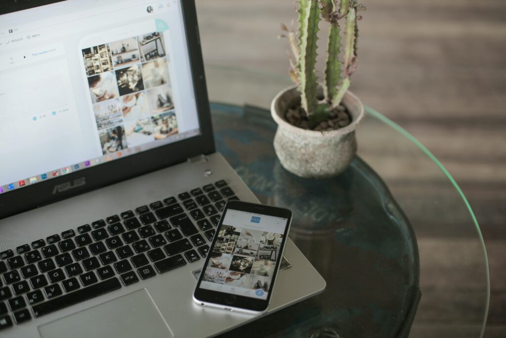 laptop and phone on a desk using instagram