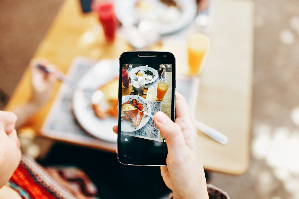 Cusotmer taking a picture of their breakfast